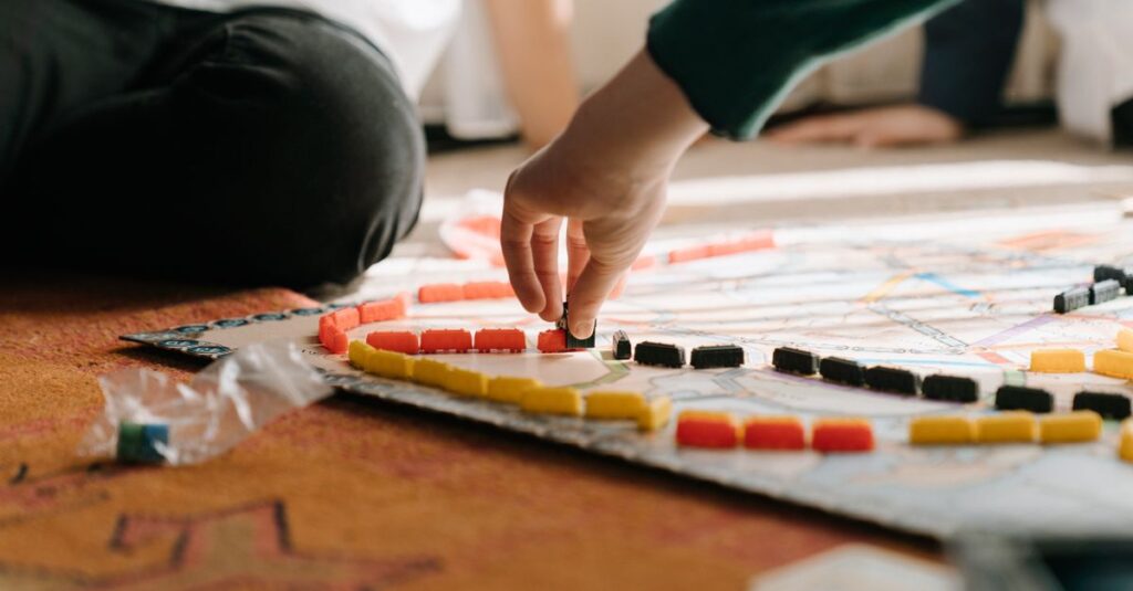 ボードゲームを片付けている家族。小さなパーツを一緒に集め、笑顔で箱に戻す様子が描かれている、温かく協力的な光景。