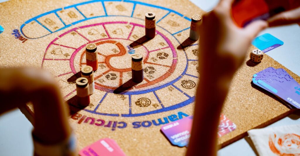 雨の日に家族が室内で知育ボードゲームを楽しむ様子。子どもから高齢者まで笑顔で参加している。