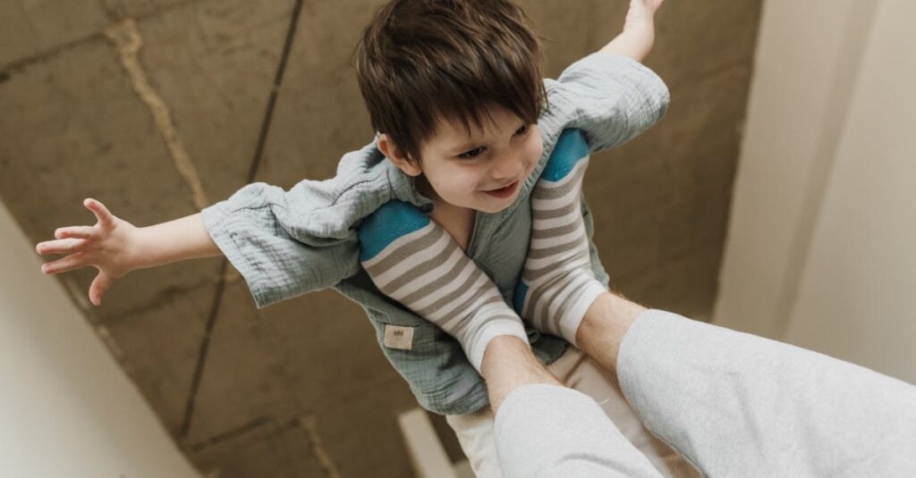 リビングで家族全員がジャンプしたり体を動かしてゲームを楽しんでいる。動きながら笑顔を見せる様子。